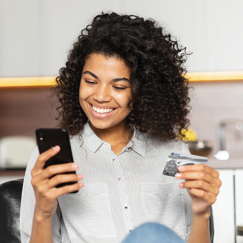 1-Young-Woman-Holding-Phone-and-Debit-Card