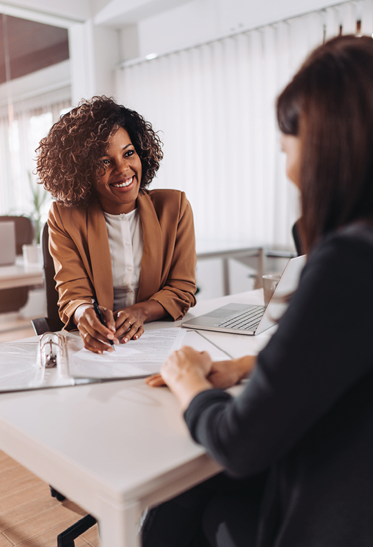 female loan specialist helping with loan application paperwork