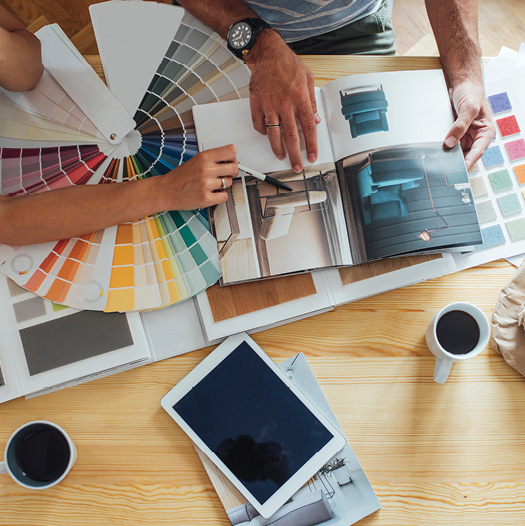 hands pointing at color paint samples as a benefit of a heloc