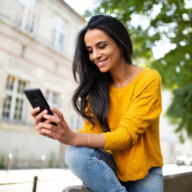 Young Woman Scheduling Appointment on Phone