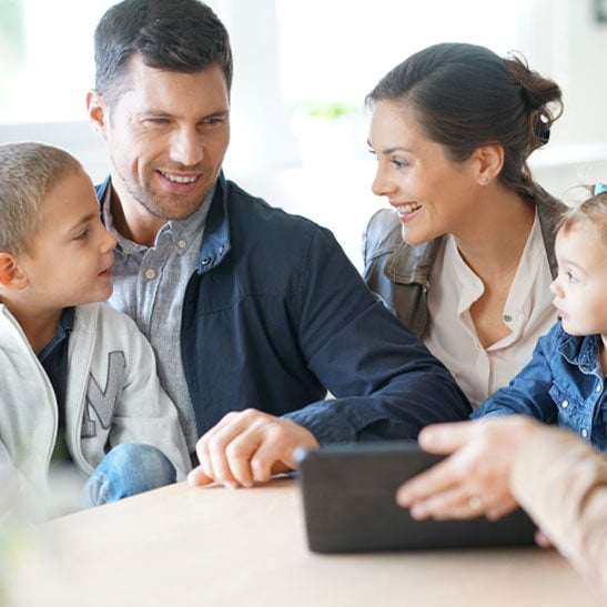 young family with financial planner talking about how to start saving for retirement with roth ira or traditional ira