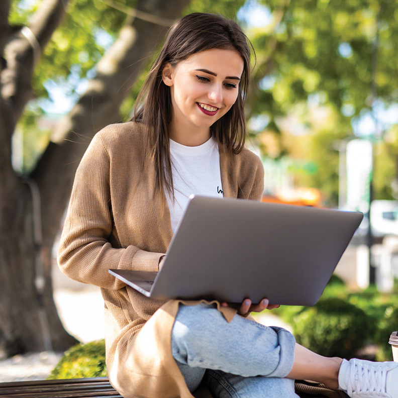 female looking at her student loans on a laptop