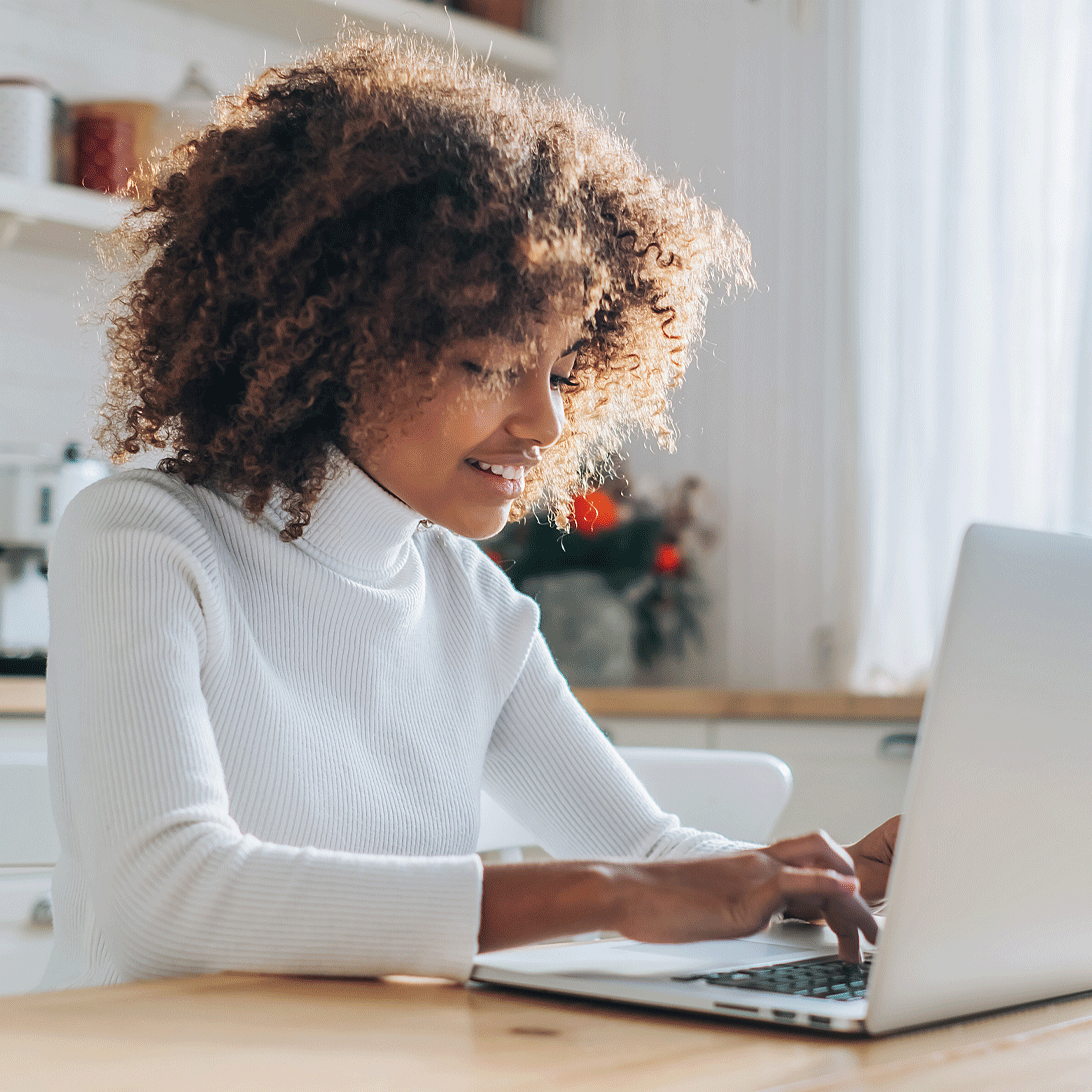 woman in white shirt on laptop searching for low auto rates