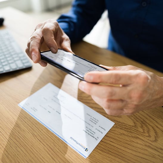 closeup of mobile check deposit with a cell phone