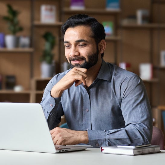 man at laptop reviewing debt consolidation application