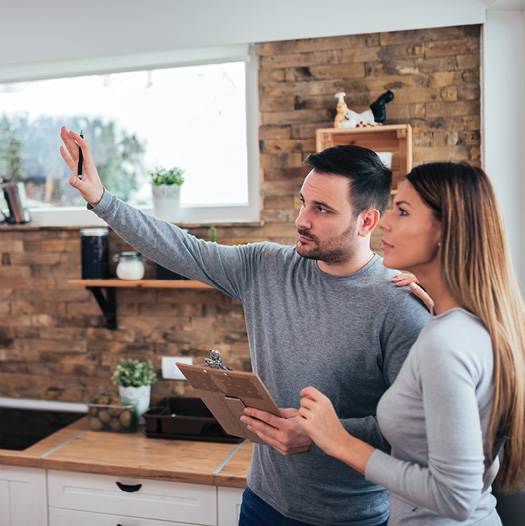 man and woman representing a couple discussing a loan for home renovations