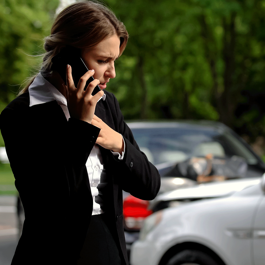 woman on the phone calling her insurance company after an auto accident