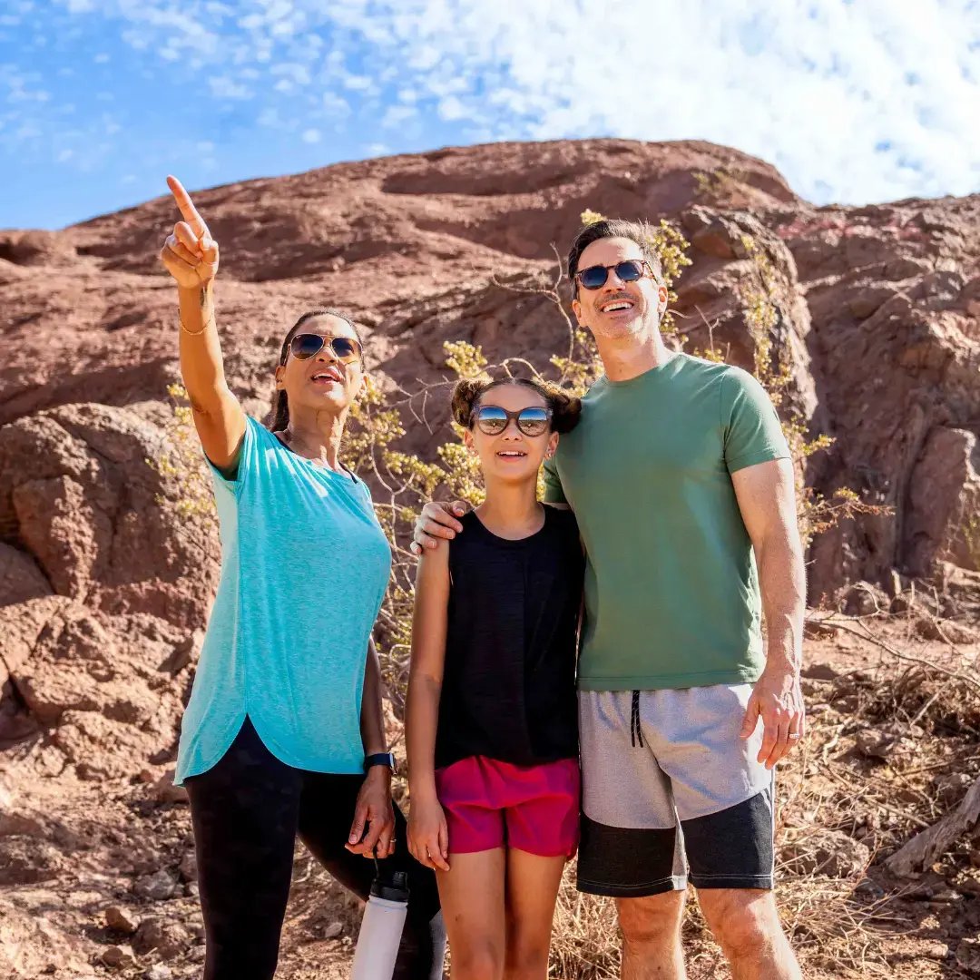 Family at papago park pointing and smiling