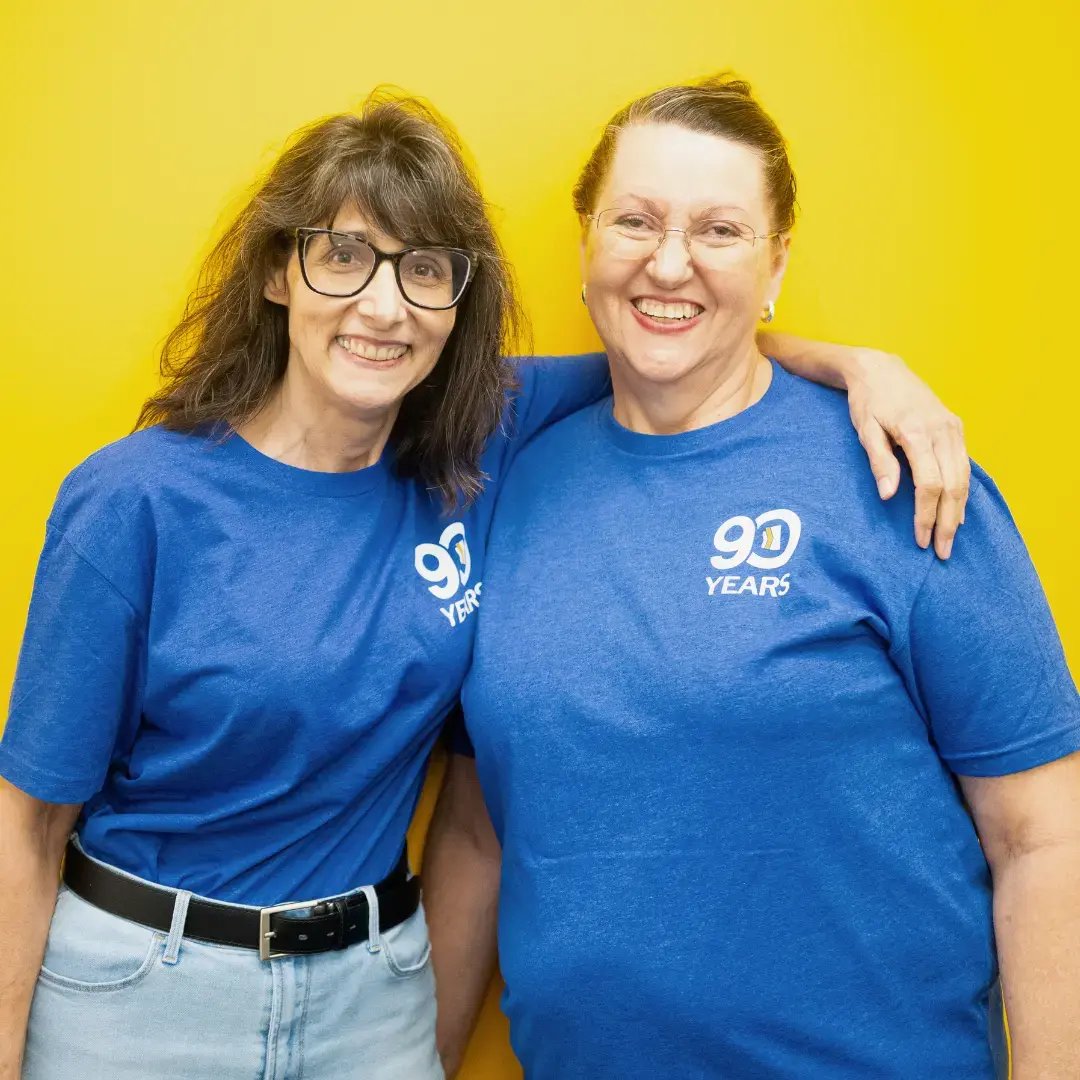 Two employees of Arizona Financial giving a side hug