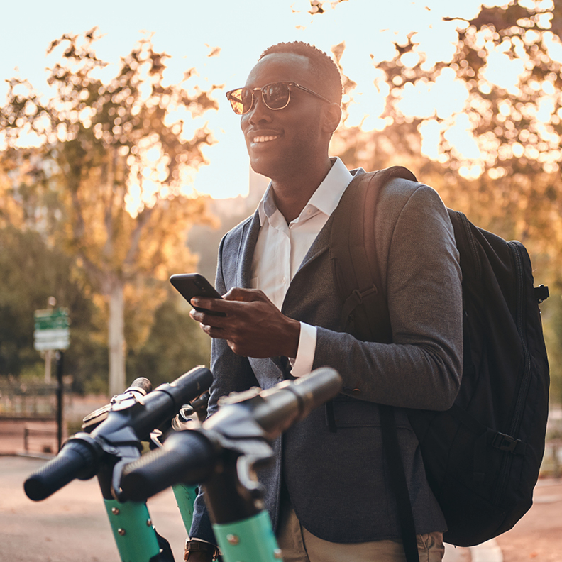 young man in sport coat with mobile phone in hand