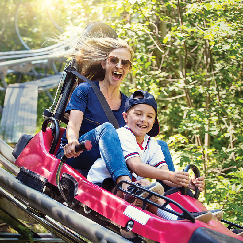 excited woman and her son on a rollercoaster 