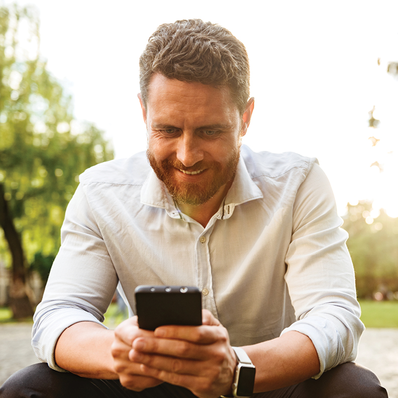 man sitting outside with mobile phone