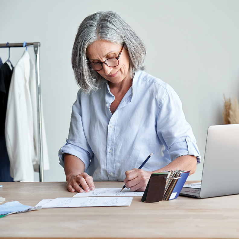 savvy business owner keeping track of excess capital from her successful design firm