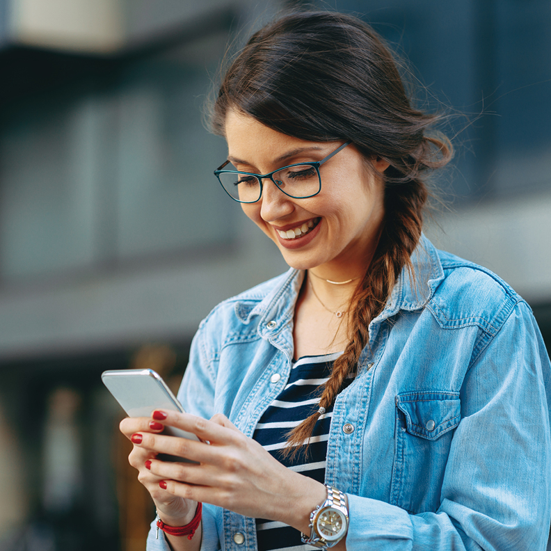 young woman with glasses on her mobile phone ordering checks