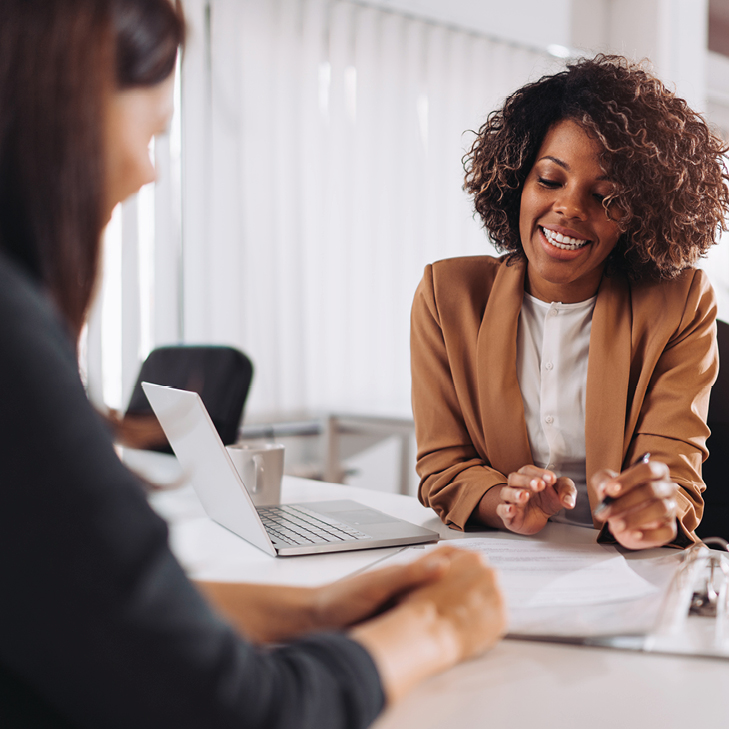 female attorney consulting a client at a table