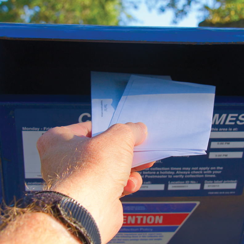 Man placing mail in mailbox