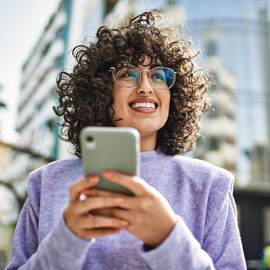 woman on mobile phone excited to get job offer at arizona financial credit union