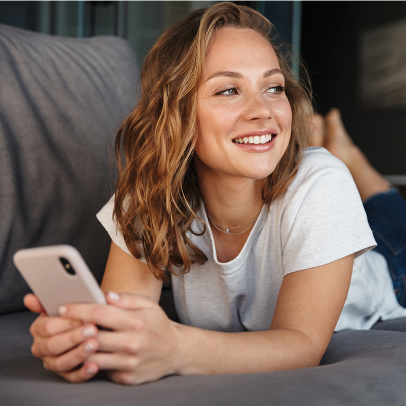 teenage girl with mobile phone smiling