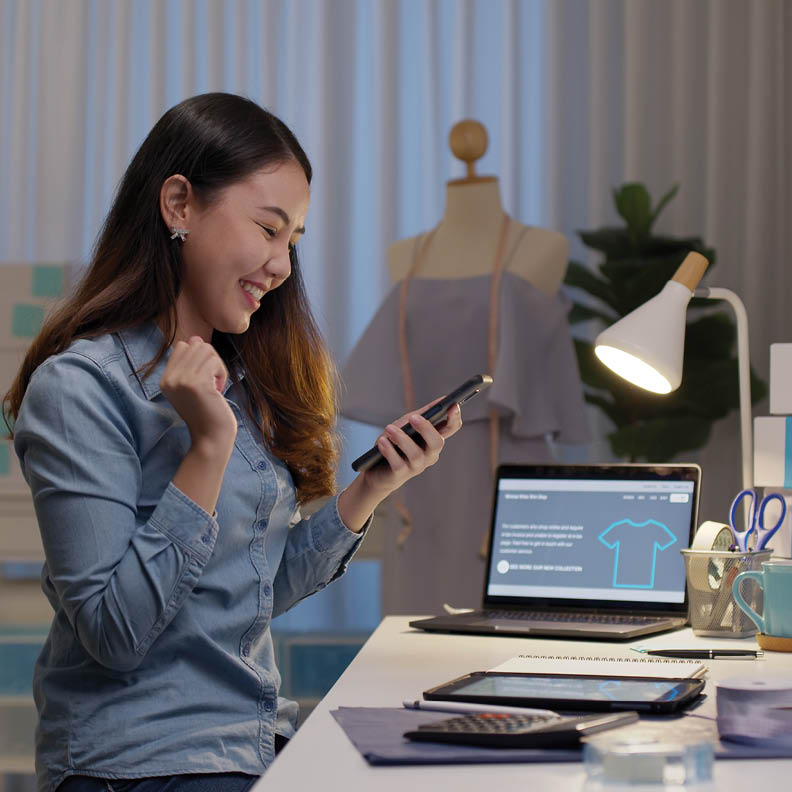 woman on mobile phone excited that her local business is growing