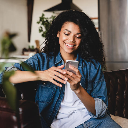 teenage girl on mobile device looking at her savings account