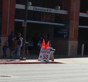 parking garage with sign charging 50 dollars for event parking
