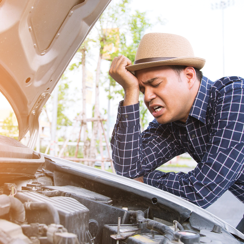 Man looking at car engine 