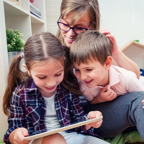 two-kids-looking-tablet-mom