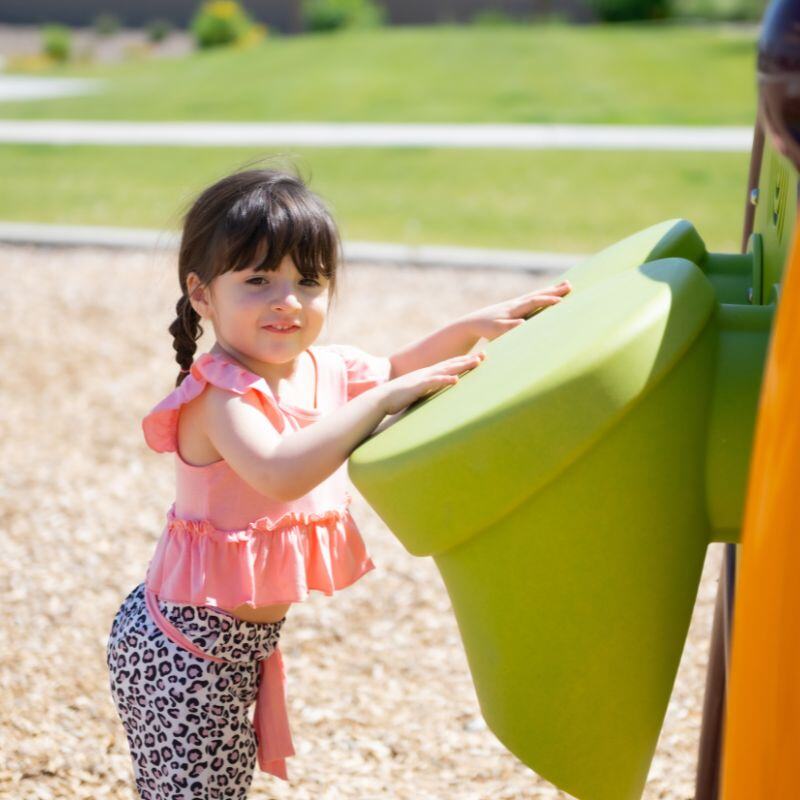 Girl in pink shirt playing in the park