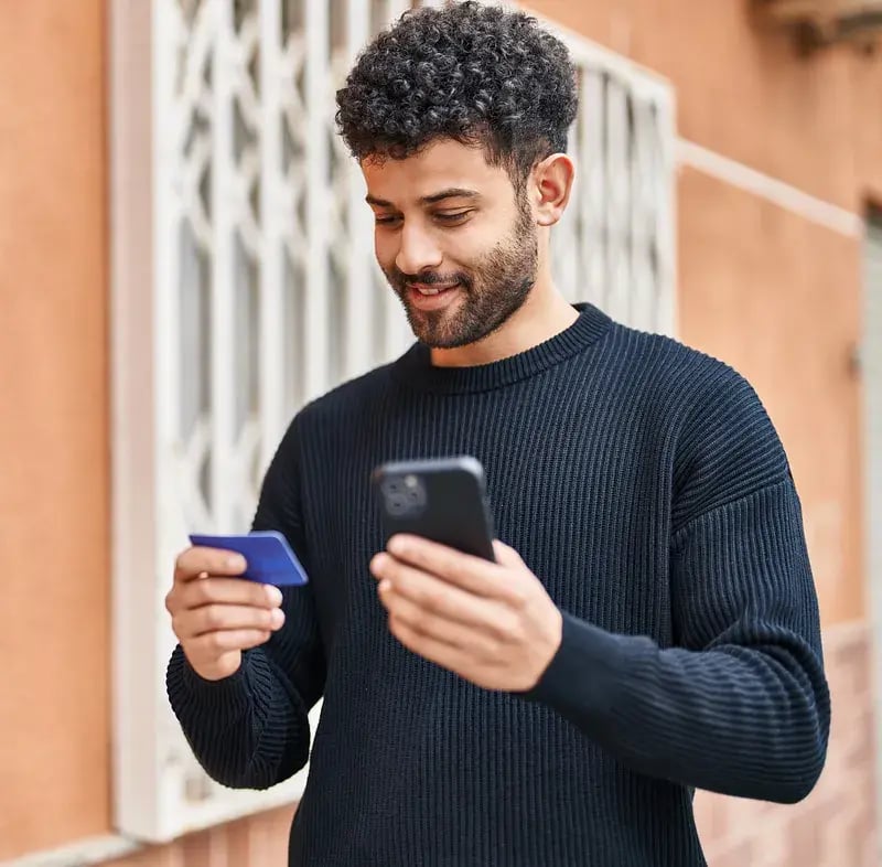 man-holding-his-phone-and-secured-card
