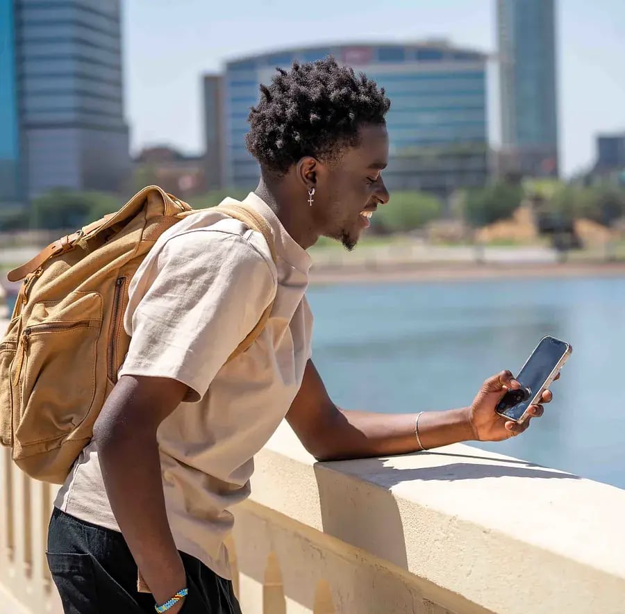 man-smiling-and-looking-at-phone