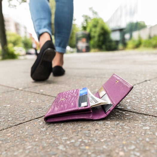 closeup of wallet with credit card on ground 