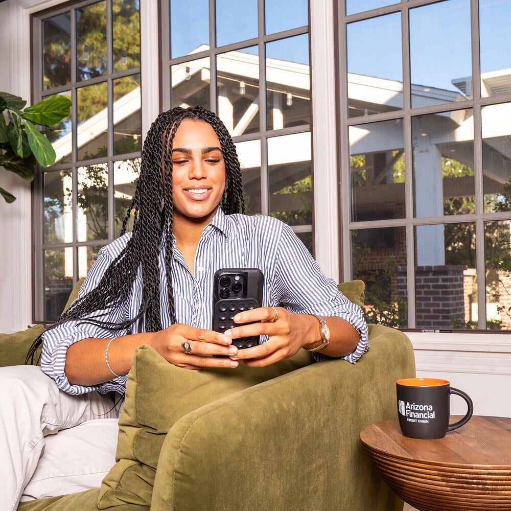 woman-smiling-and-looking-at-phone