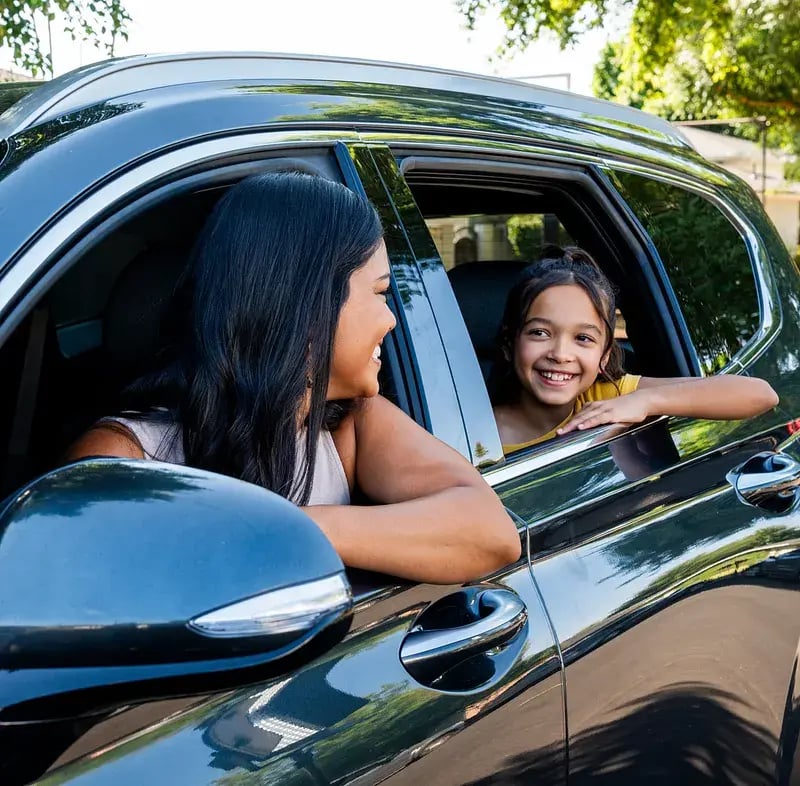 woman-with-kid-about-to-drive-away-in-new-car