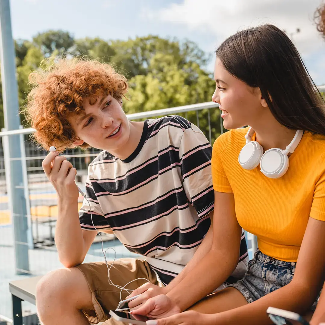 Teens sitting on park bench